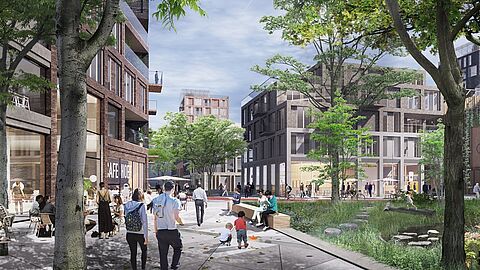 Impressie van van een pleintje met groen en gebouwen erom heen